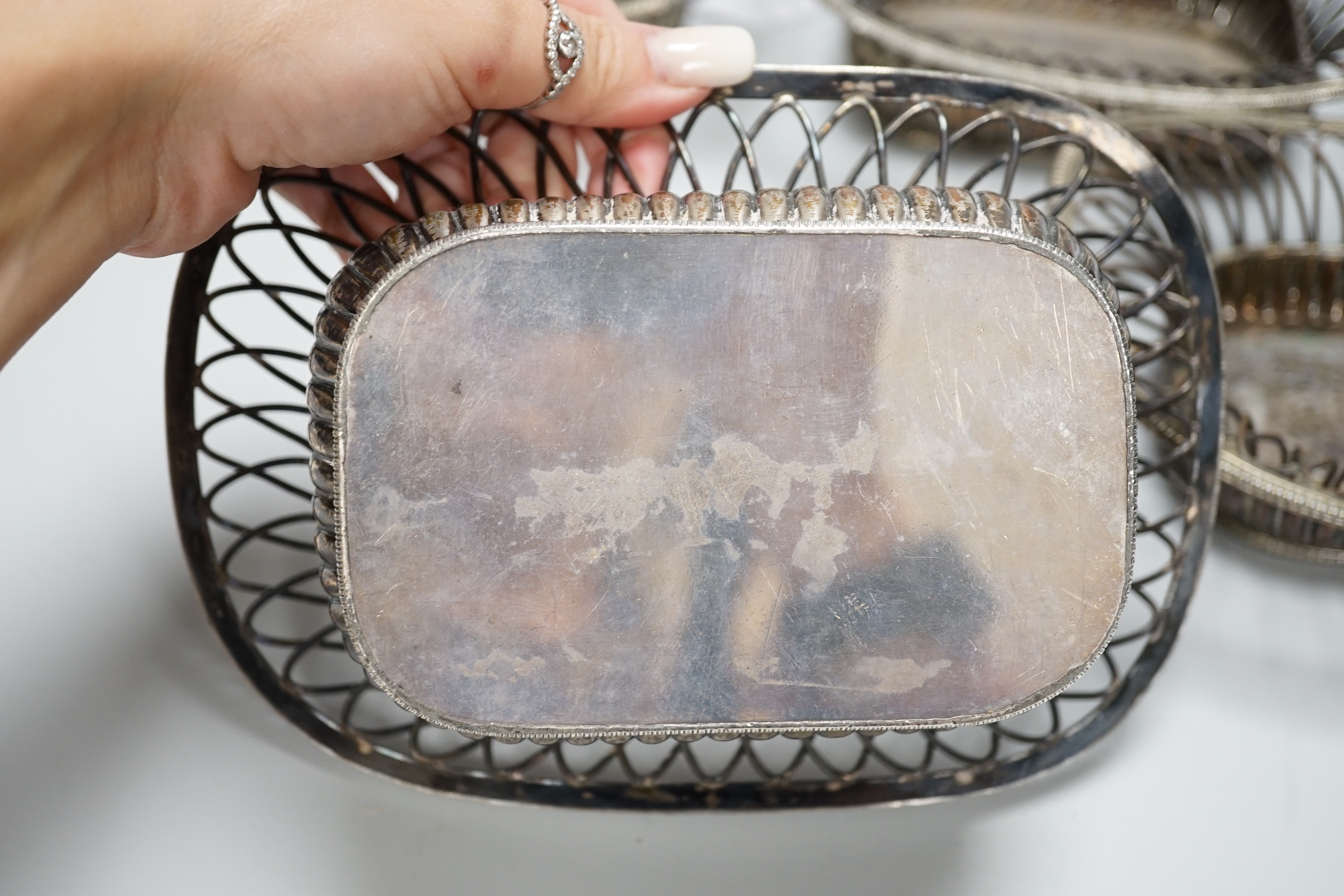 Four silver plated wire-work baskets, each 21cm wide